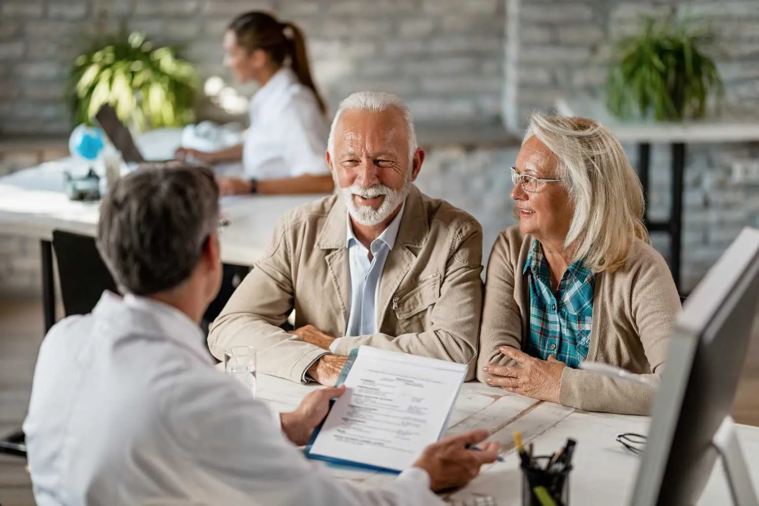 Senior adults confidently discussing Medicare options with trusted advisor